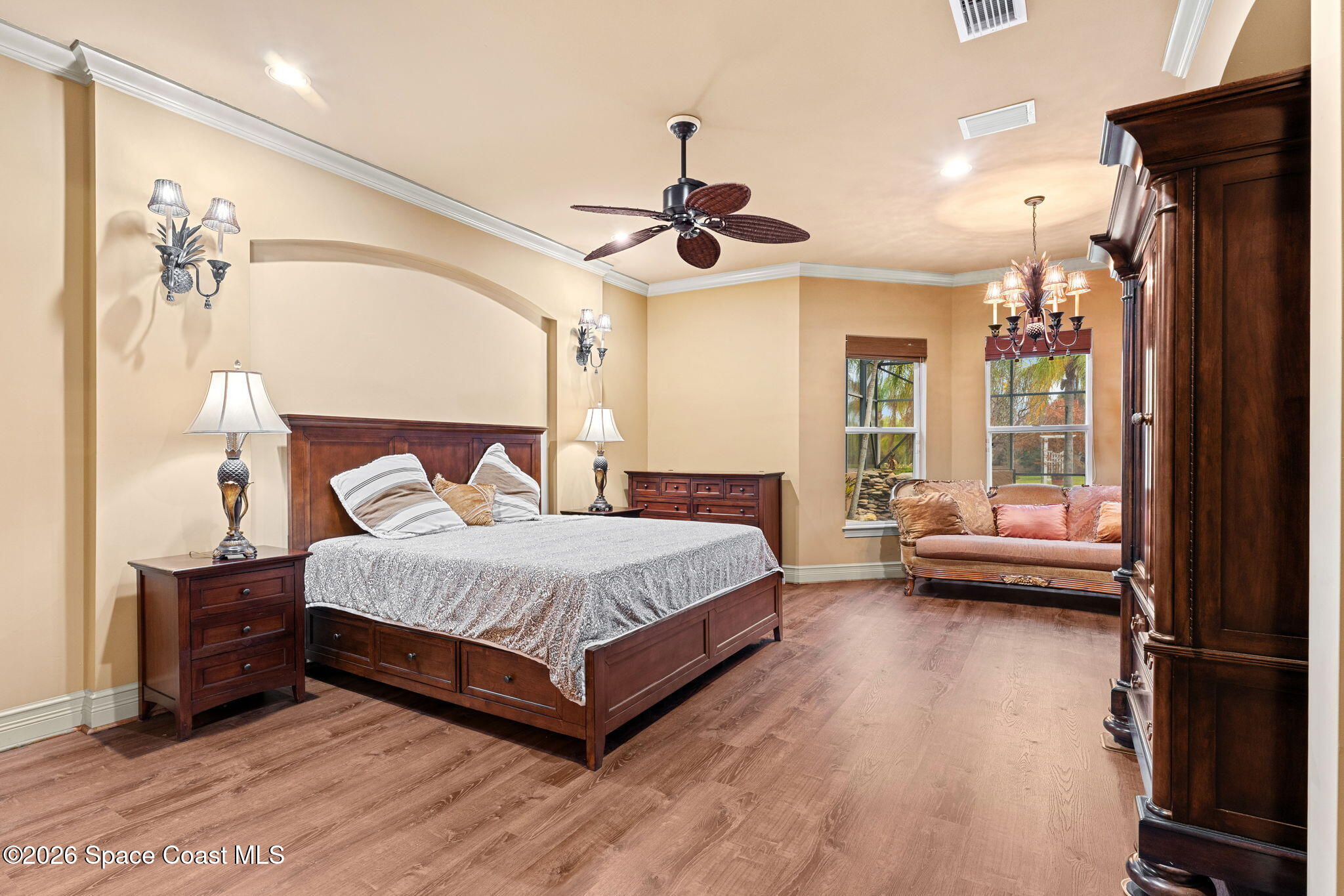 5137 Royal Paddock Way Merritt Island, FL 32953 - Photo 41 of 132 a spacious bedroom with a bed and a chandelier