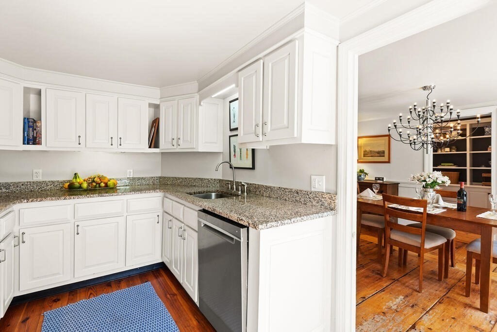 38 Washington Street Marblehead, MA 01945 - Photo 11 of 32 a kitchen with stainless steel appliances granite countertop a stove a sink and white cabinets