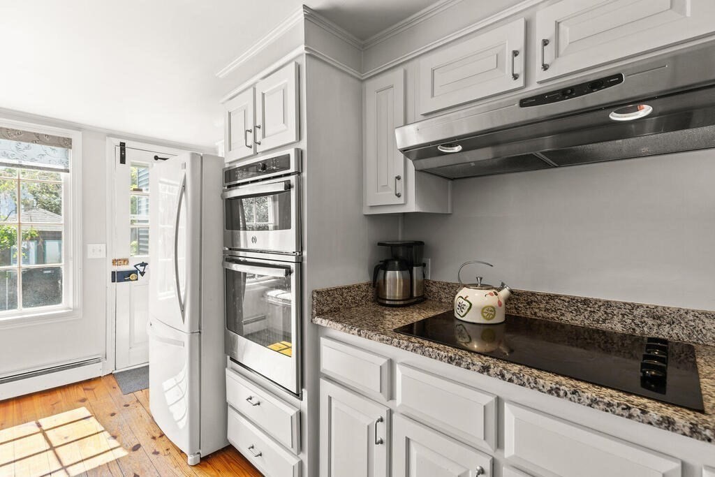 38 Washington Street Marblehead, MA 01945 - Photo 13 of 32 a kitchen with stainless steel appliances granite countertop a refrigerator and a stove