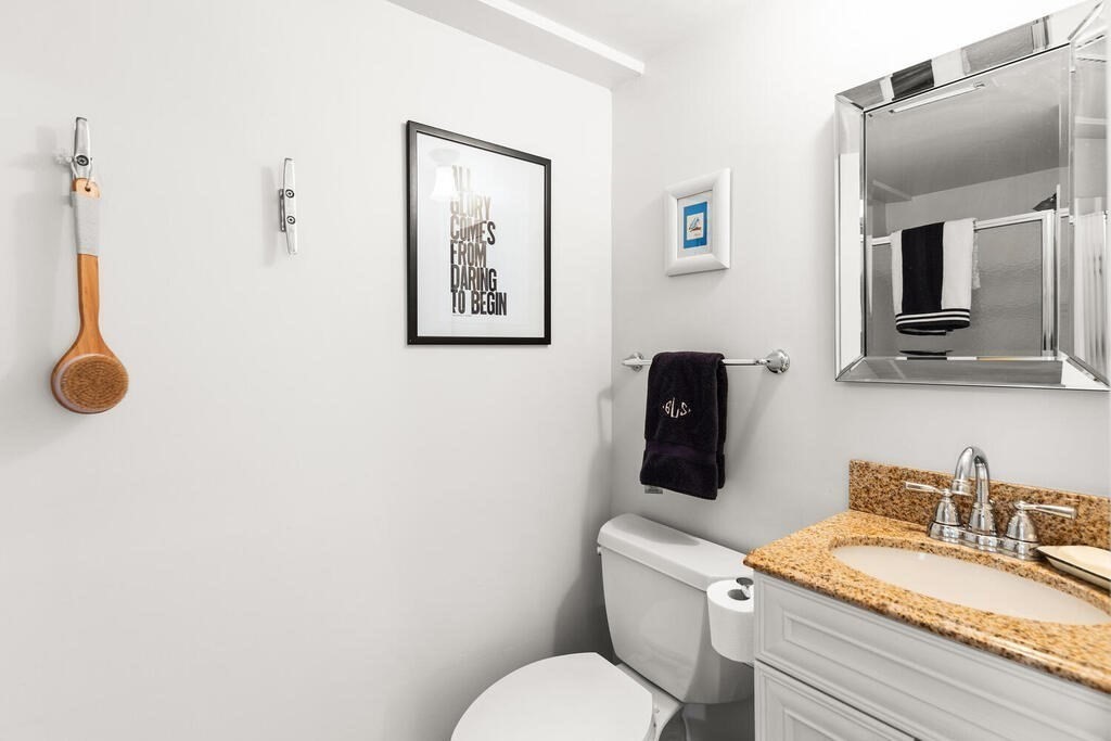 38 Washington Street Marblehead, MA 01945 - Photo 20 of 32 a bathroom with a granite countertop toilet sink and mirror
