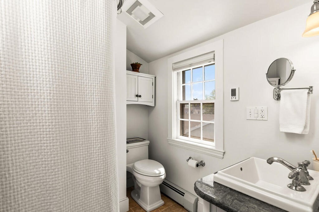 38 Washington Street Marblehead, MA 01945 - Photo 23 of 32 a bathroom with a sink a toilet and mirror
