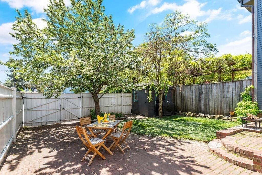 38 Washington Street Marblehead, MA 01945 - Photo 26 of 32 a backyard of a house with table and chairs