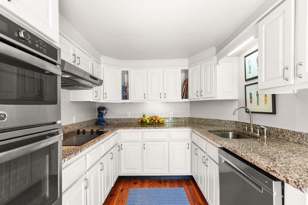 38 Washington Street Marblehead, MA 01945 - Photo 10 of 32 a kitchen with granite countertop a sink stainless steel appliances and cabinets