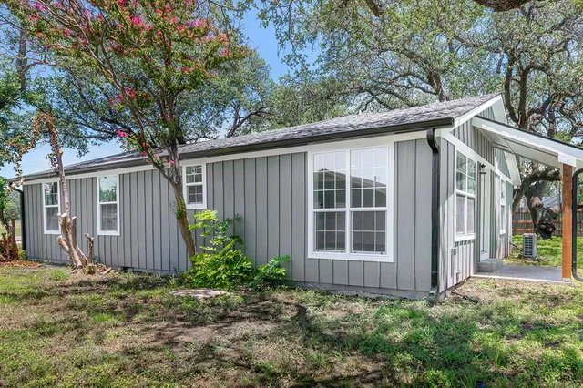 a view of a house with a yard and plants