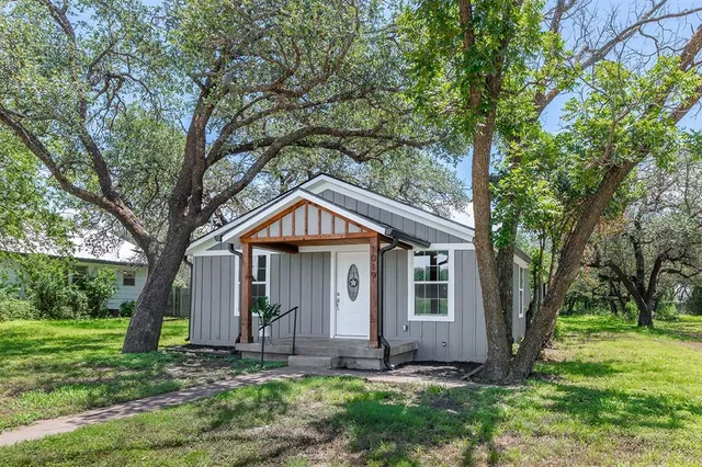 a front view of a house with a yard