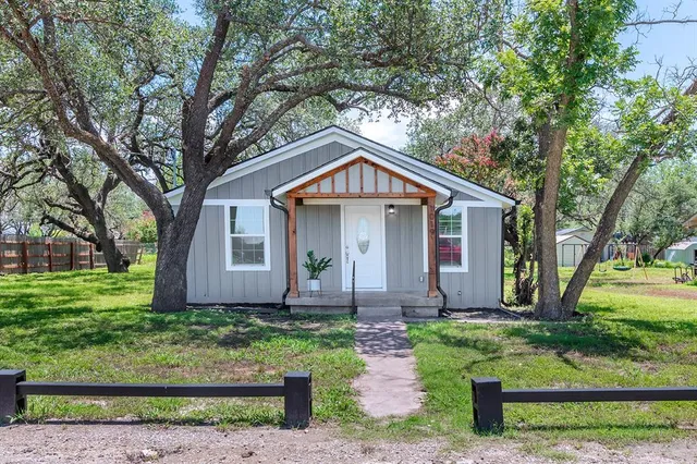 a front view of house with yard and green space
