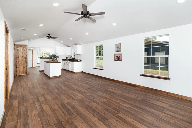 a view of a kitchen with a sink and wooden floor