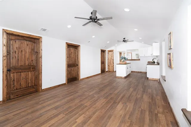 a view of a kitchen with a sink and a refrigerator