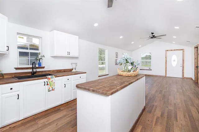 a kitchen with stainless steel appliances granite countertop a sink stove and wooden floor