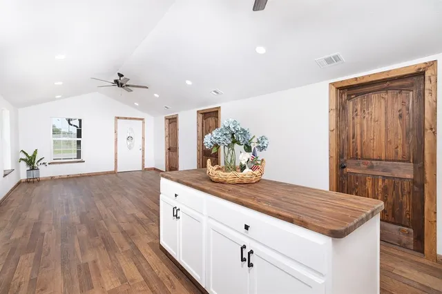 a kitchen with a wooden floor and outdoor space