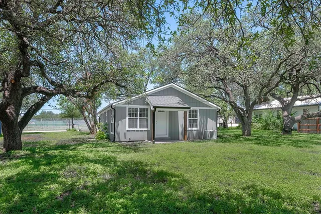 a front view of house with yard and green space