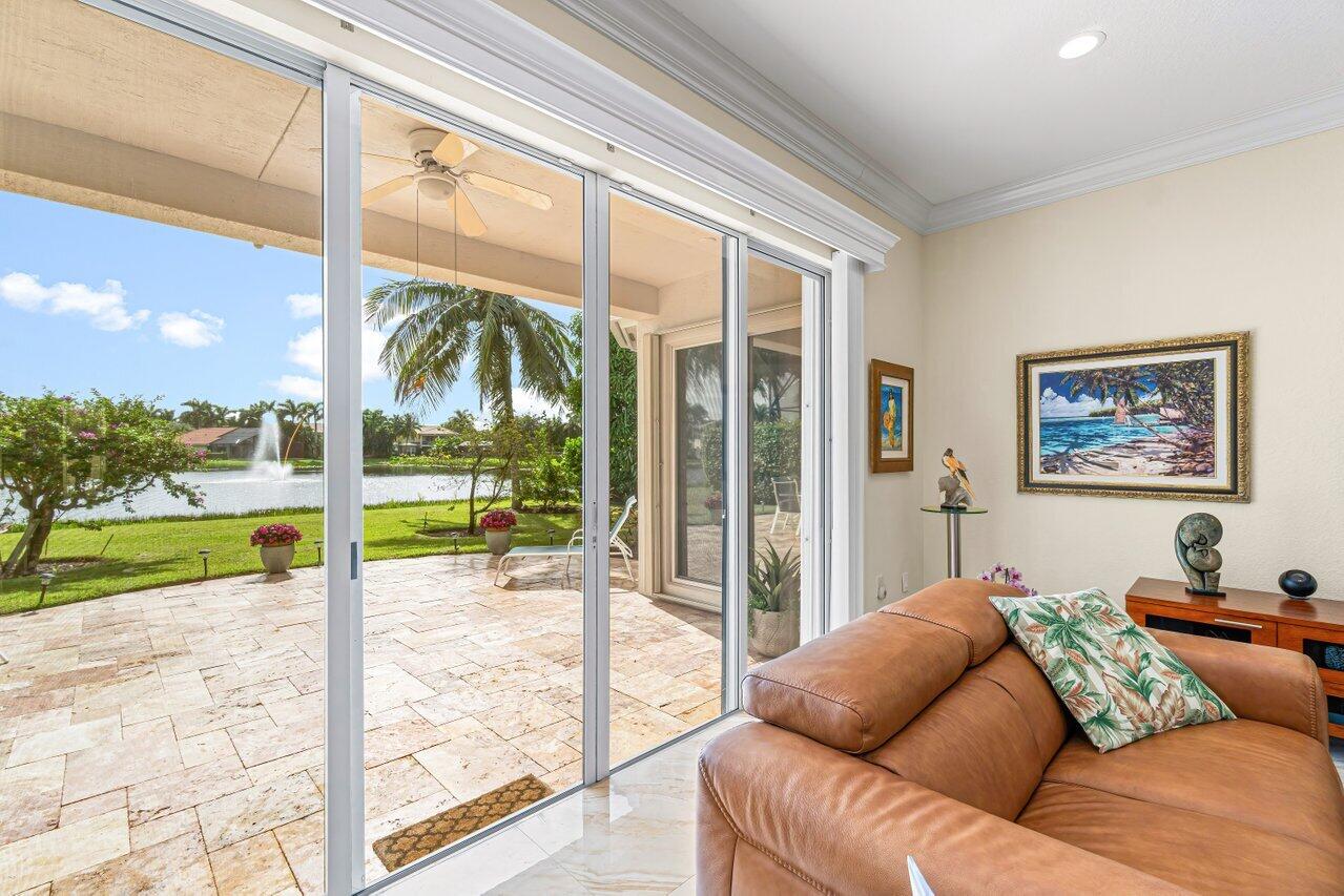 10822 Sunset Ridge Circle Boynton Beach, FL 33473 - Photo 12 of 99 a living room with couch and a floor to ceiling windows