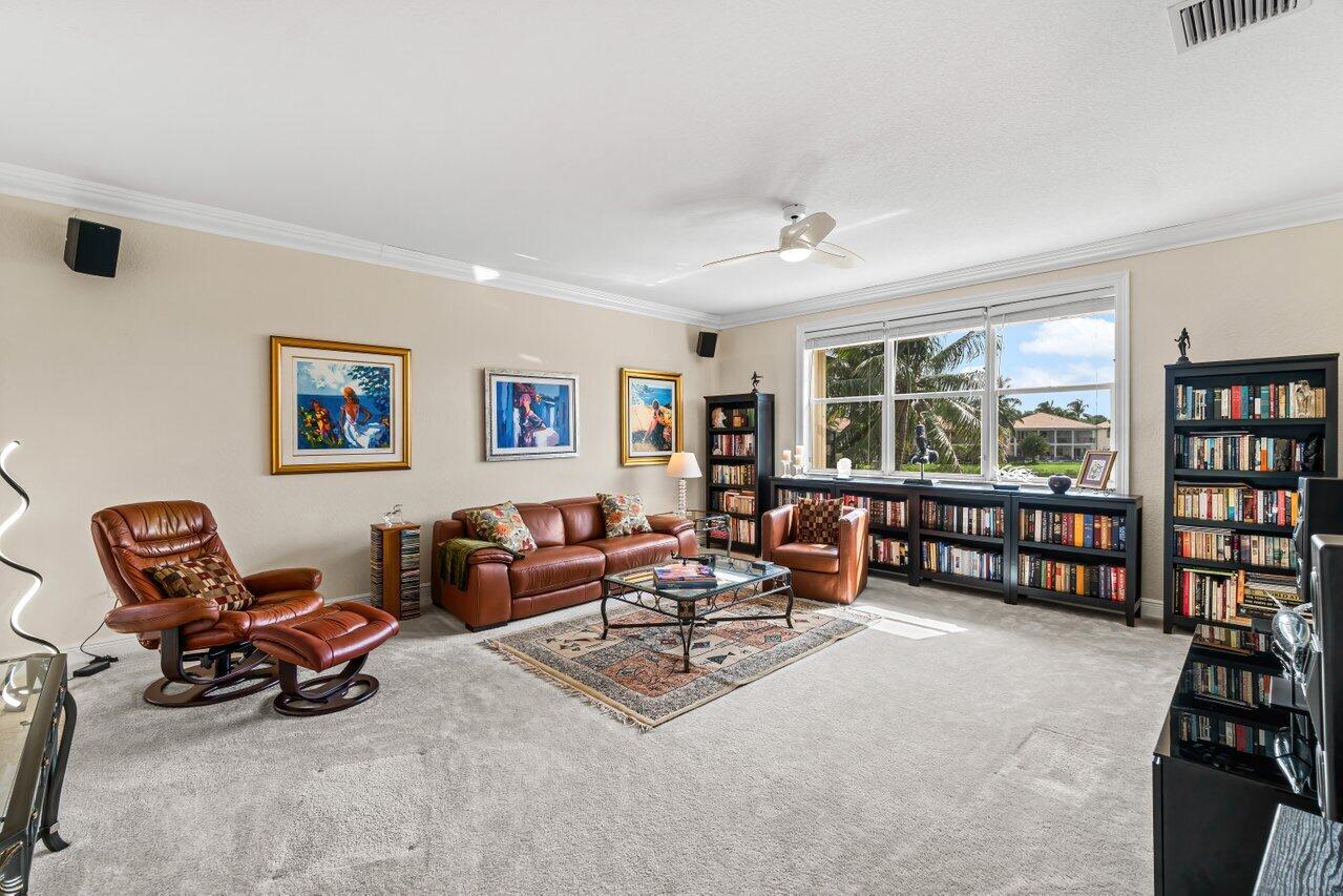 10822 Sunset Ridge Circle Boynton Beach, FL 33473 - Photo 33 of 99 a living room with furniture and a book shelf