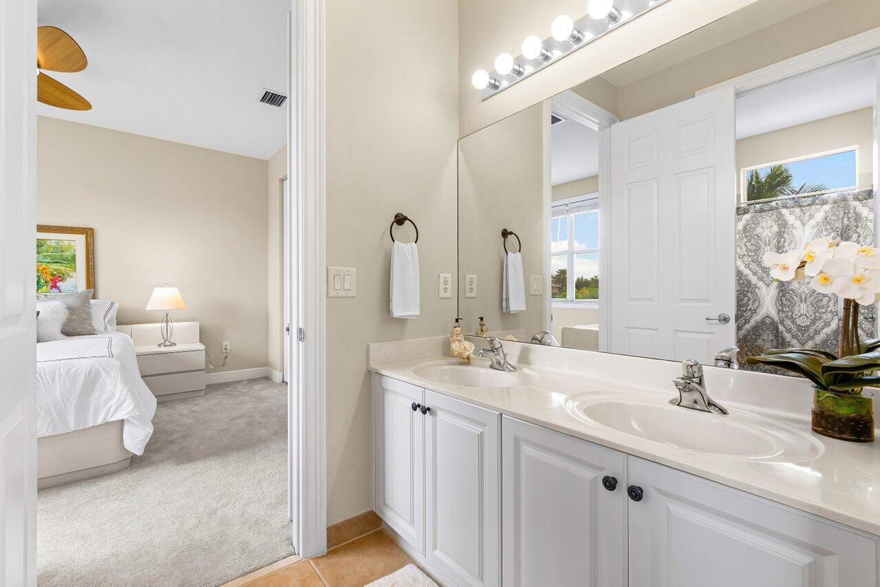 10822 Sunset Ridge Circle Boynton Beach, FL 33473 - Photo 41 of 99 a en suite bathroom with double sink and a mirror
