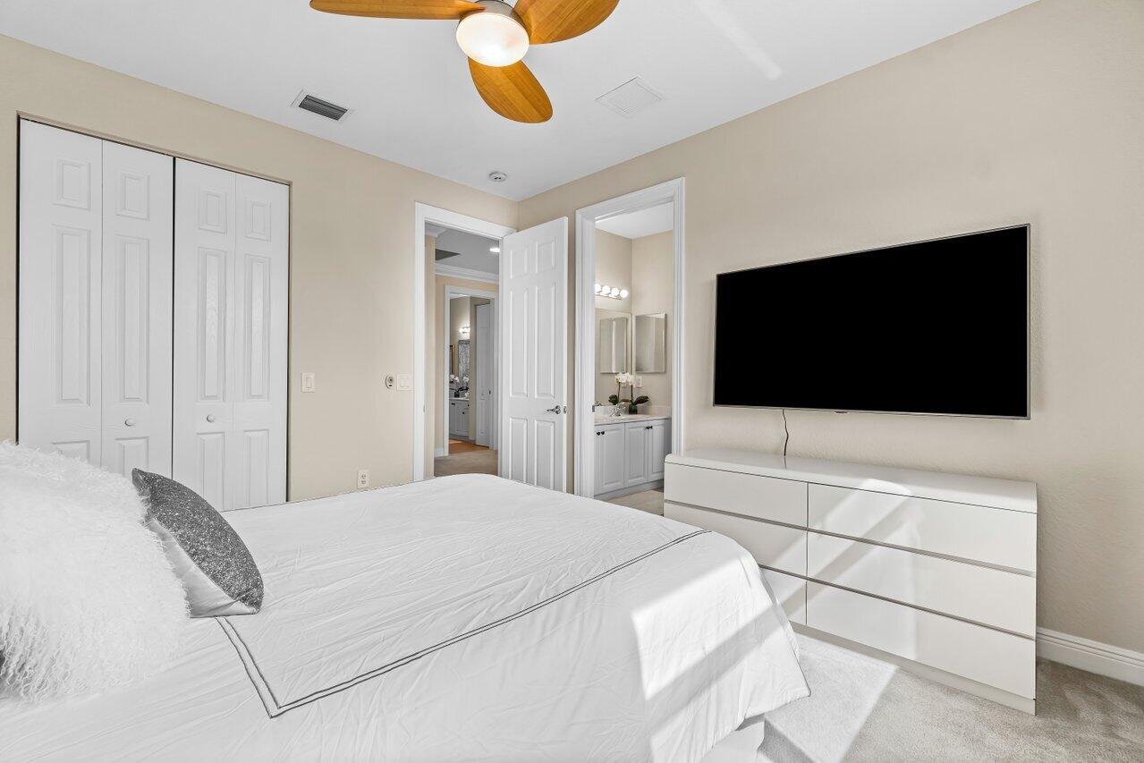10822 Sunset Ridge Circle Boynton Beach, FL 33473 - Photo 45 of 99 a bedroom with a bed and a flat screen tv