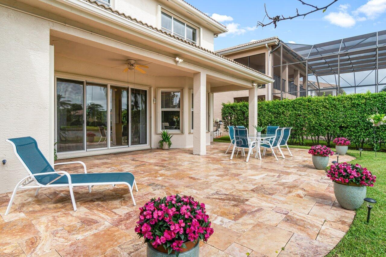 10822 Sunset Ridge Circle Boynton Beach, FL 33473 - Photo 56 of 99 a view of a patio with a table and chairs and potted plants