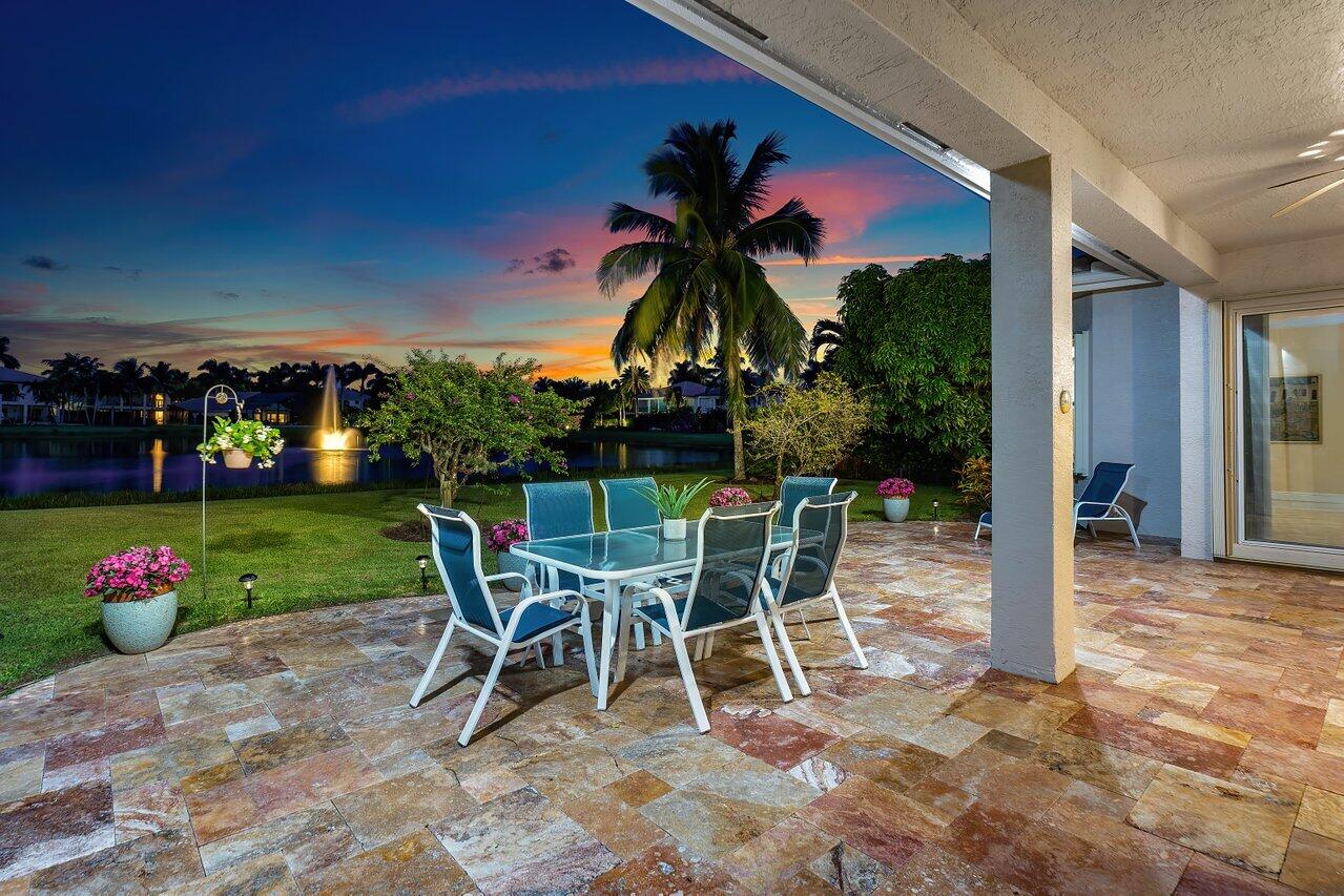10822 Sunset Ridge Circle Boynton Beach, FL 33473 - Photo 58 of 99 a view of a table and chairs in patio with a yard