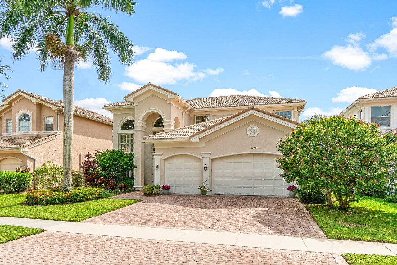 10822 Sunset Ridge Circle Boynton Beach, FL 33473 - Photo 70 of 99 a front view of a house with a yard and garage