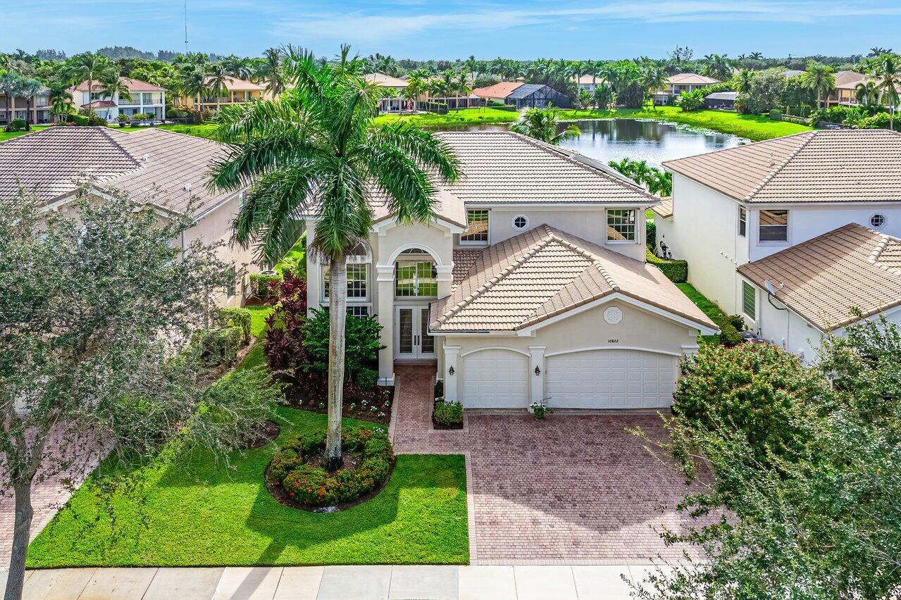 10822 Sunset Ridge Circle Boynton Beach, FL 33473 - Photo 74 of 99 an aerial view of a house with a yard and lake view