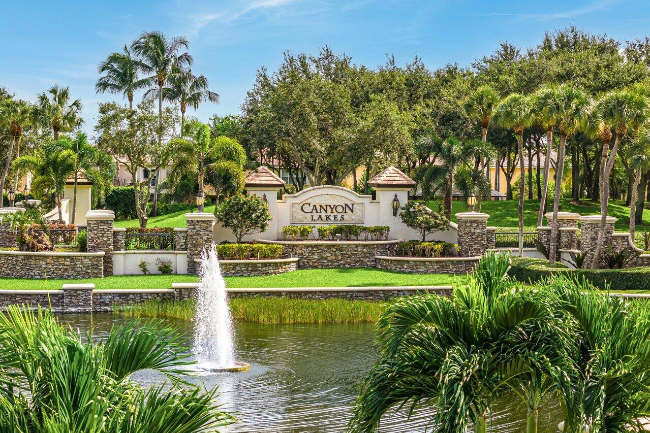 10822 Sunset Ridge Circle Boynton Beach, FL 33473 - Photo 77 of 99 a view of a water pond with green yard