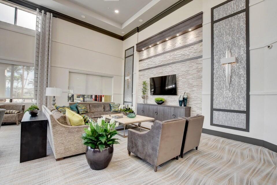 10822 Sunset Ridge Circle Boynton Beach, FL 33473 - Photo 84 of 99 a living room with furniture potted plant and a flat screen tv