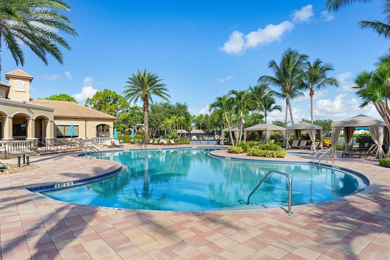10822 Sunset Ridge Circle Boynton Beach, FL 33473 - Photo 93 of 99 a view of a swimming pool with lounge chair