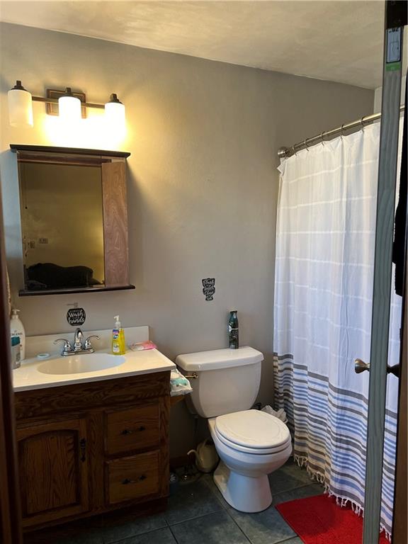 110 Walters Street Derry, PA 15627 - Photo 7 of 16 a bathroom with a toilet sink and mirror