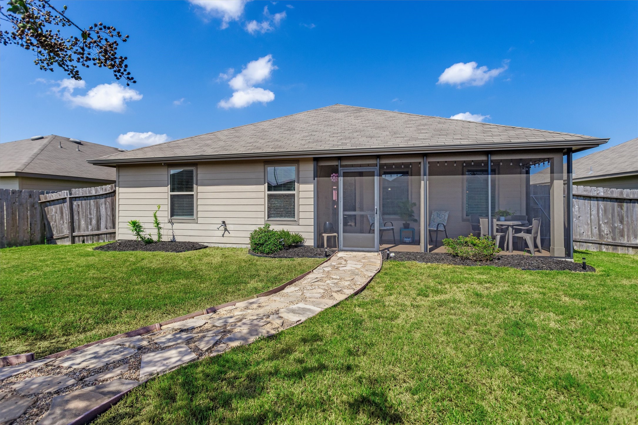 1711 Martin Spring Lane Rosenberg, TX 77469 - Photo 21 of 24 Enjoy a generous Backyard with plenty of green space and a charming stone pathway leading to the Screened-In Porch.