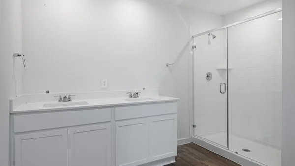 a bathroom with a shower sink vanity and mirror