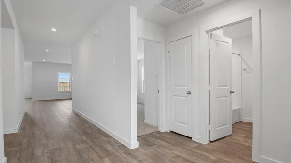 a view of a hallway with wooden floor
