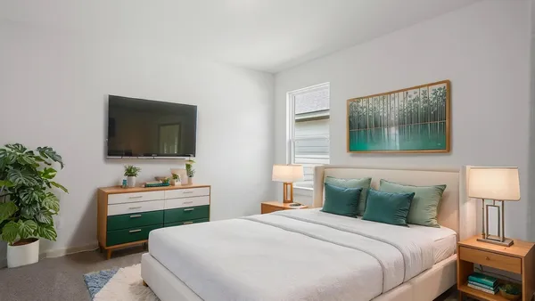 a bedroom with a bed and a flat screen tv