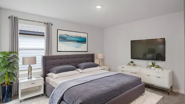a bedroom with a bed and a flat screen tv