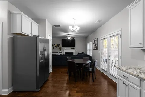 a kitchen with refrigerator cabinets dining table and chairs