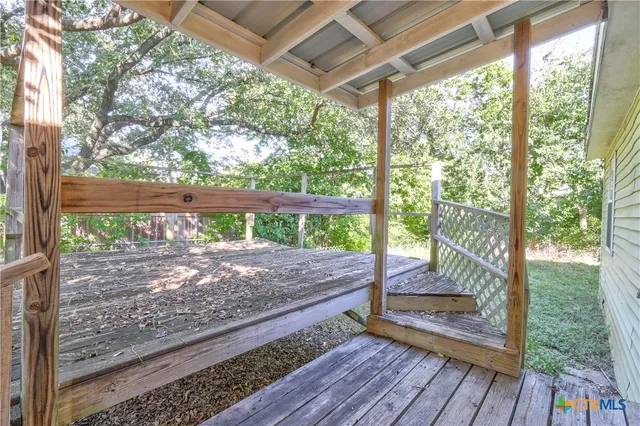 a view of a porch with wooden floor