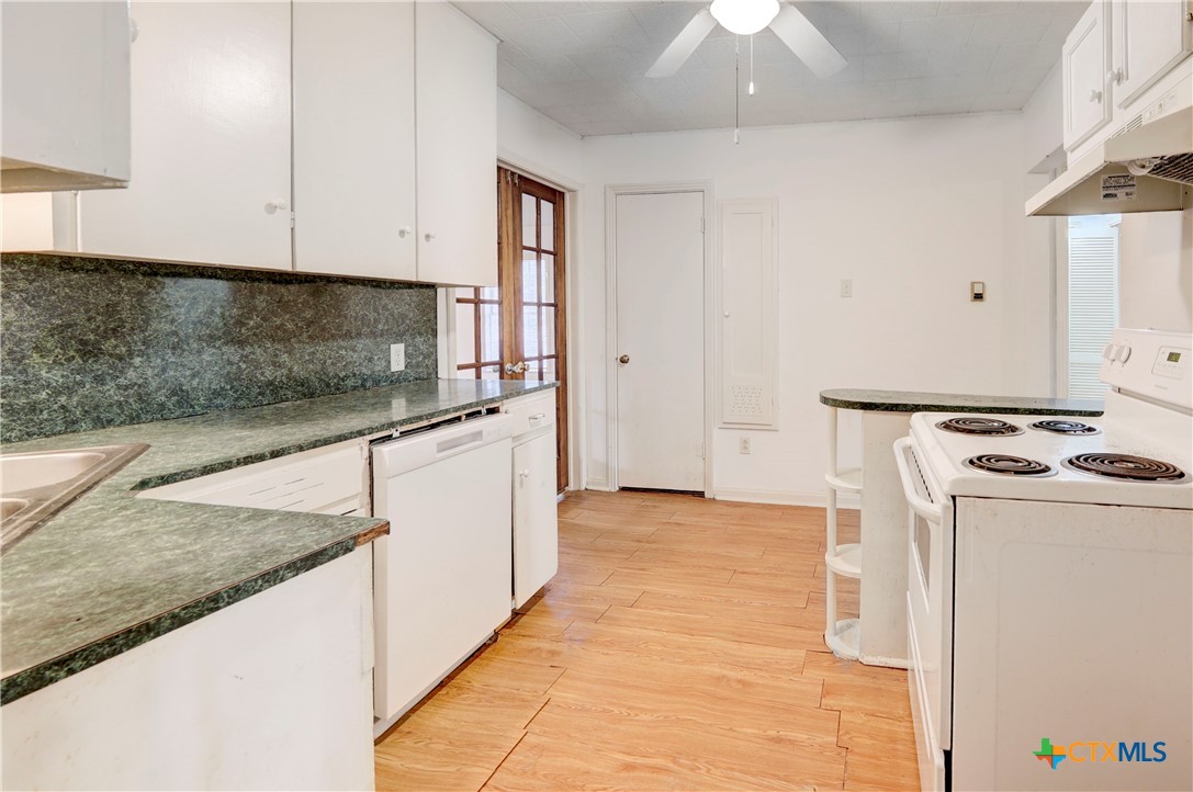1415 North 7th Street Temple, TX 76501 - Photo 5 of 14 a kitchen with stainless steel appliances granite countertop a sink and a stove