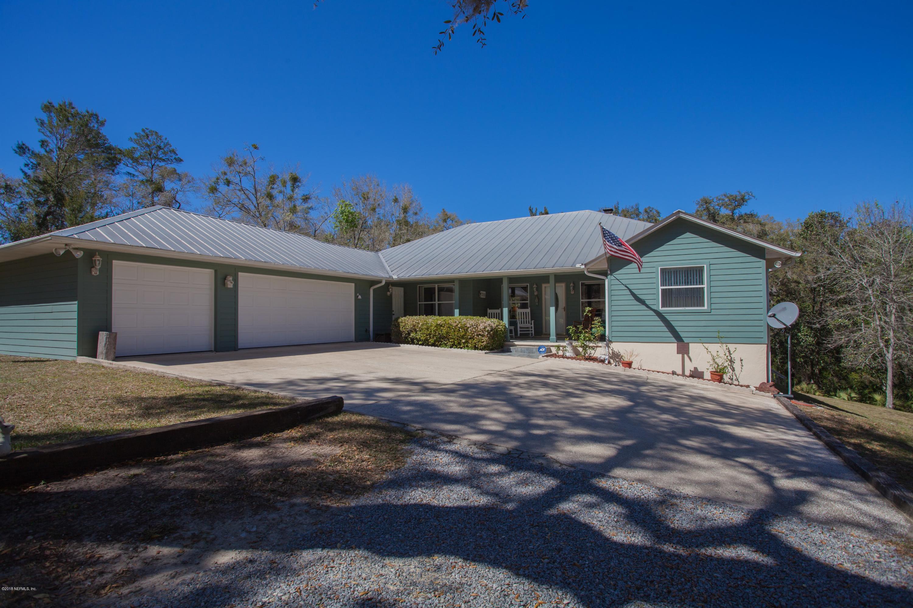 7986 National Forest Road Palatka, FL 32177 - Photo 1 of 31 a front view of a house with a garden