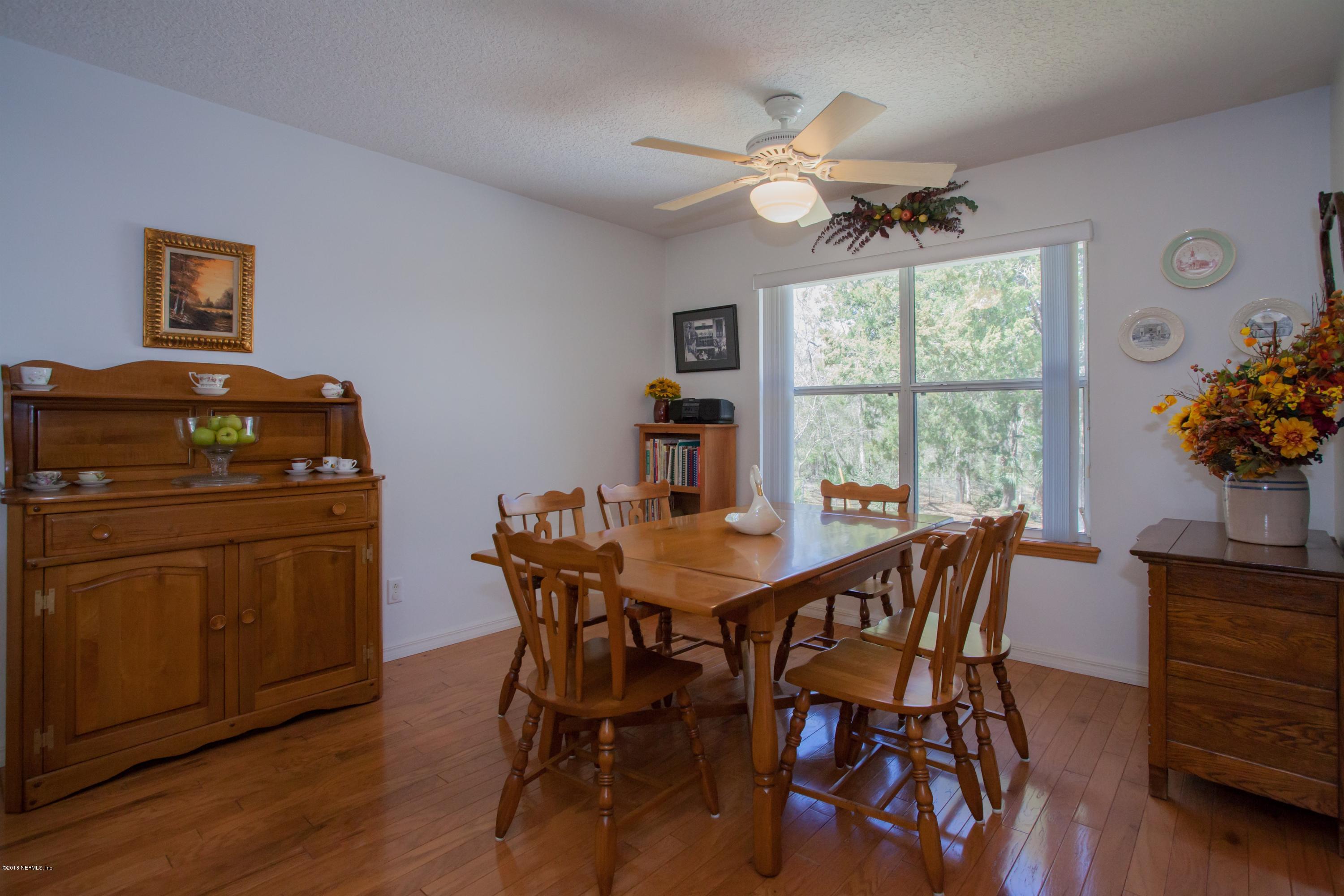 7986 National Forest Road Palatka, FL 32177 - Photo 13 of 31 a view of a dining room with furniture window and wooden floor