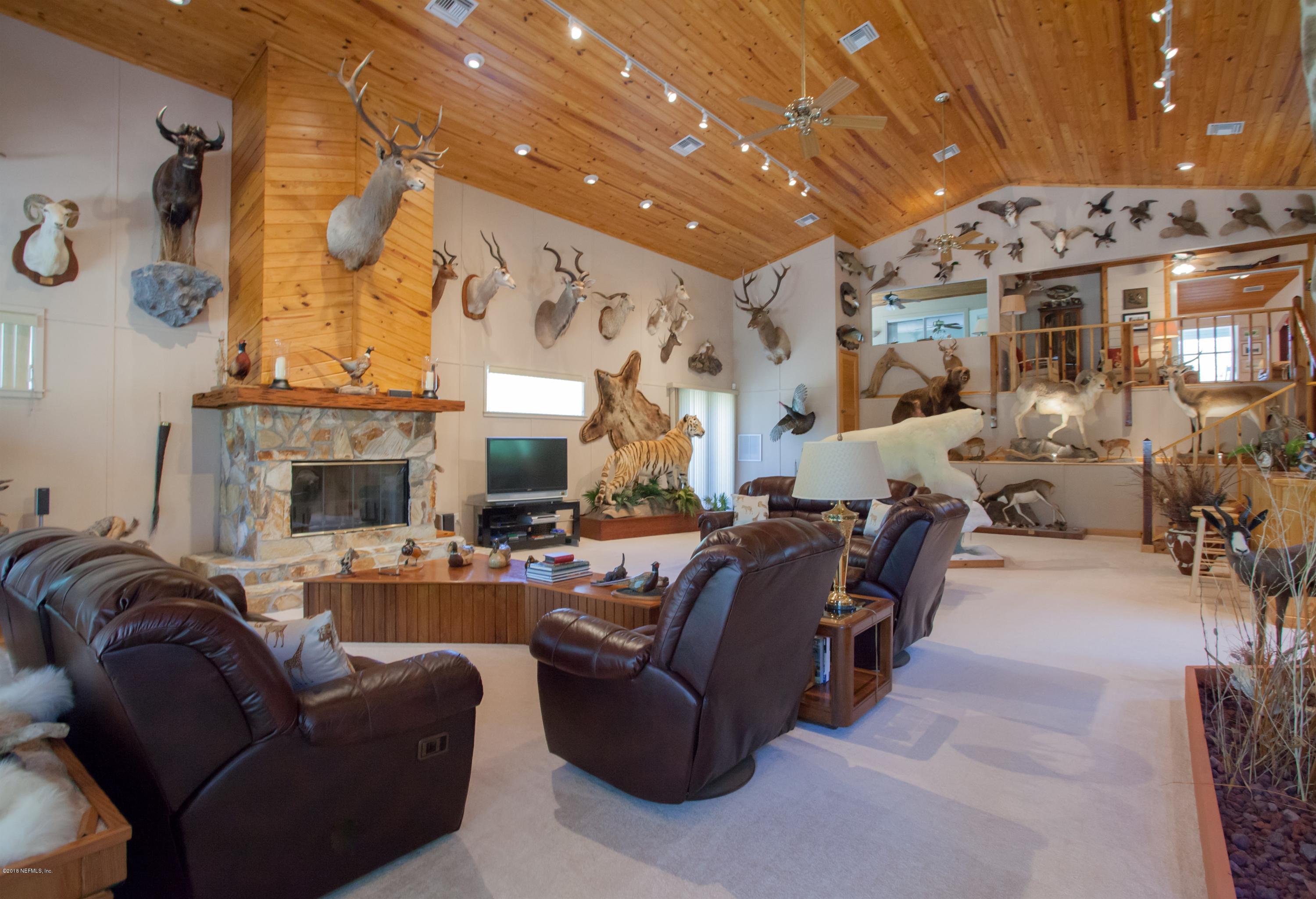 7986 National Forest Road Palatka, FL 32177 - Photo 15 of 31 a living room with furniture and a fireplace