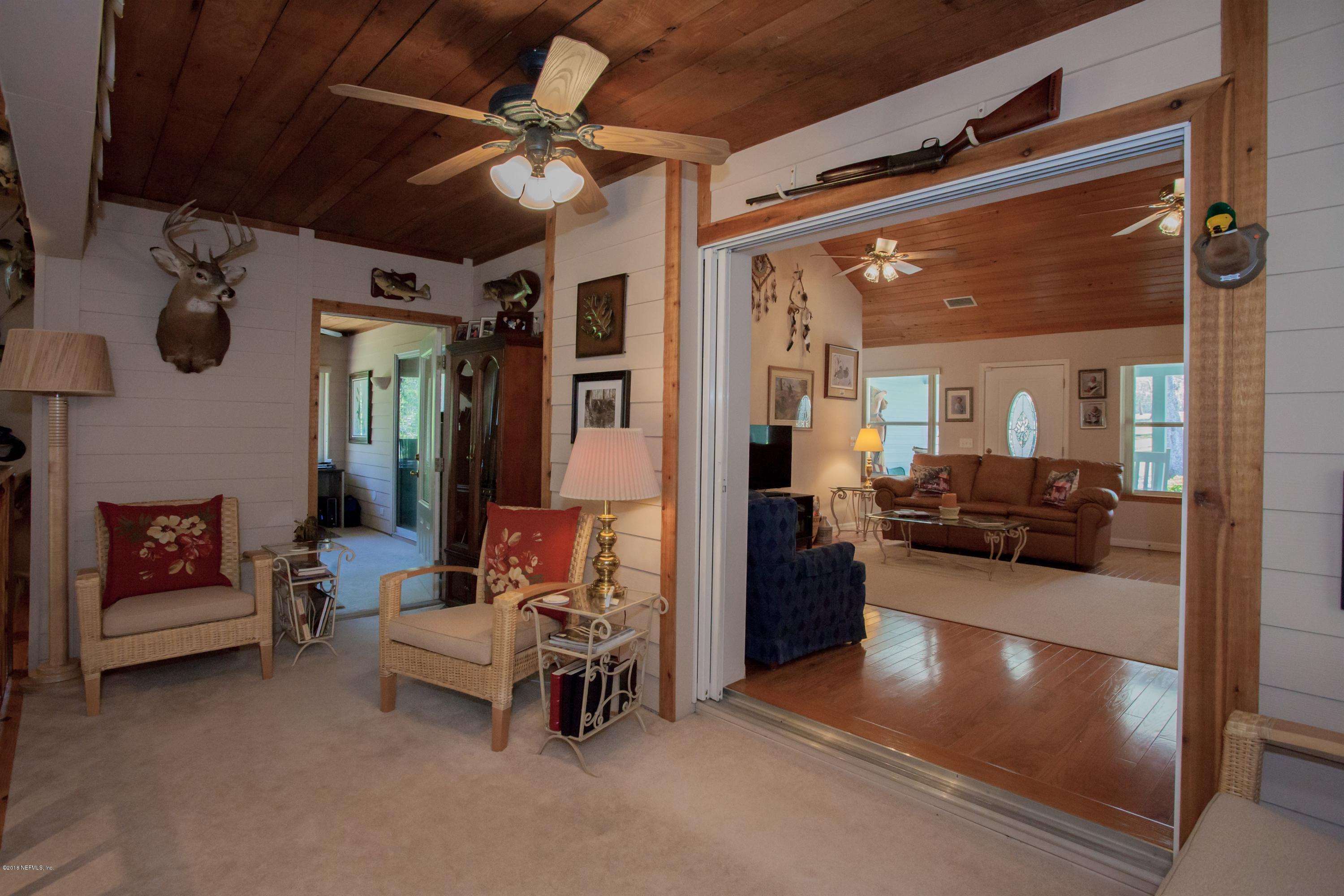 7986 National Forest Road Palatka, FL 32177 - Photo 16 of 31 a living room with furniture and a chandelier