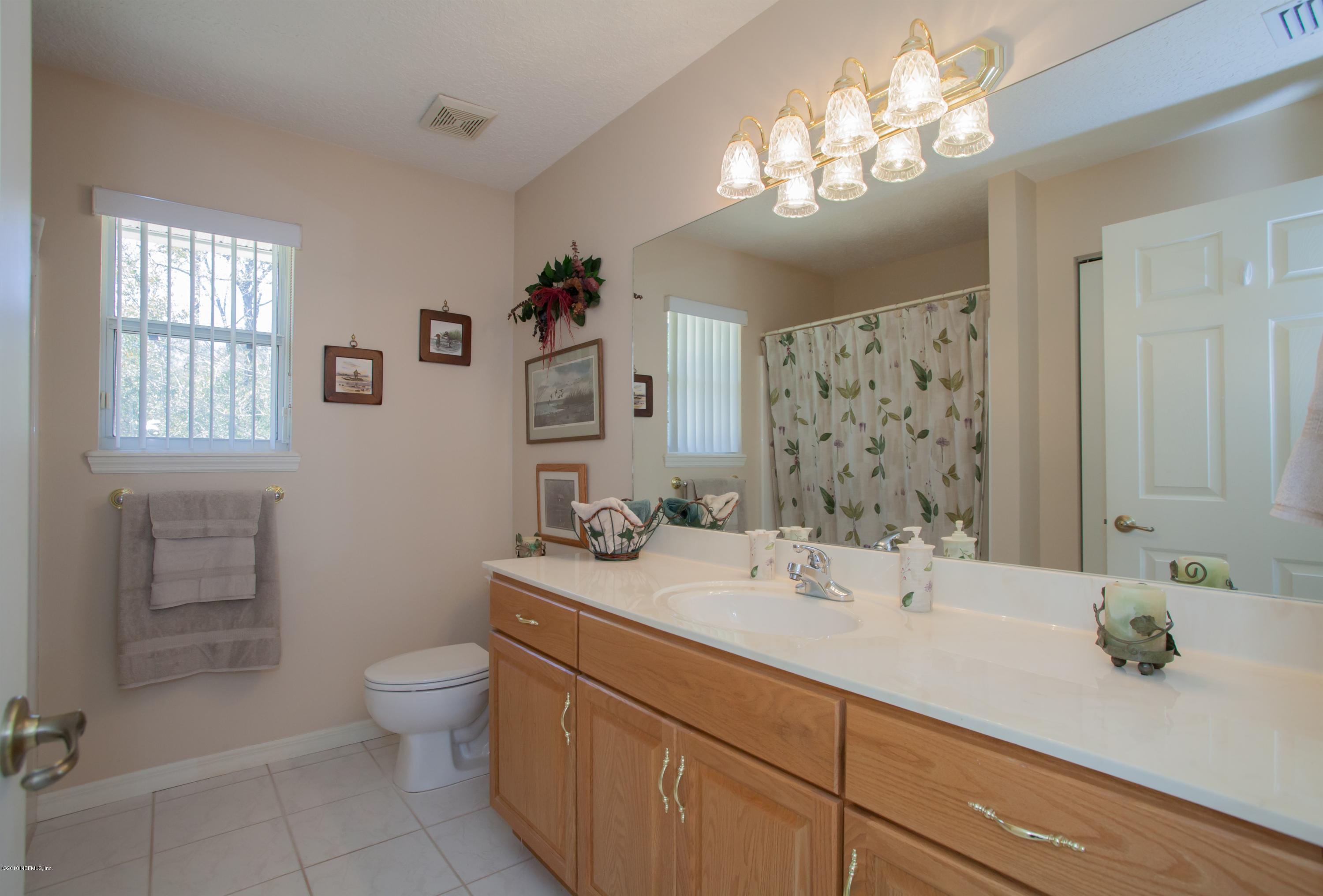 7986 National Forest Road Palatka, FL 32177 - Photo 21 of 31 a bathroom with a double vanity sink toilet and a mirror