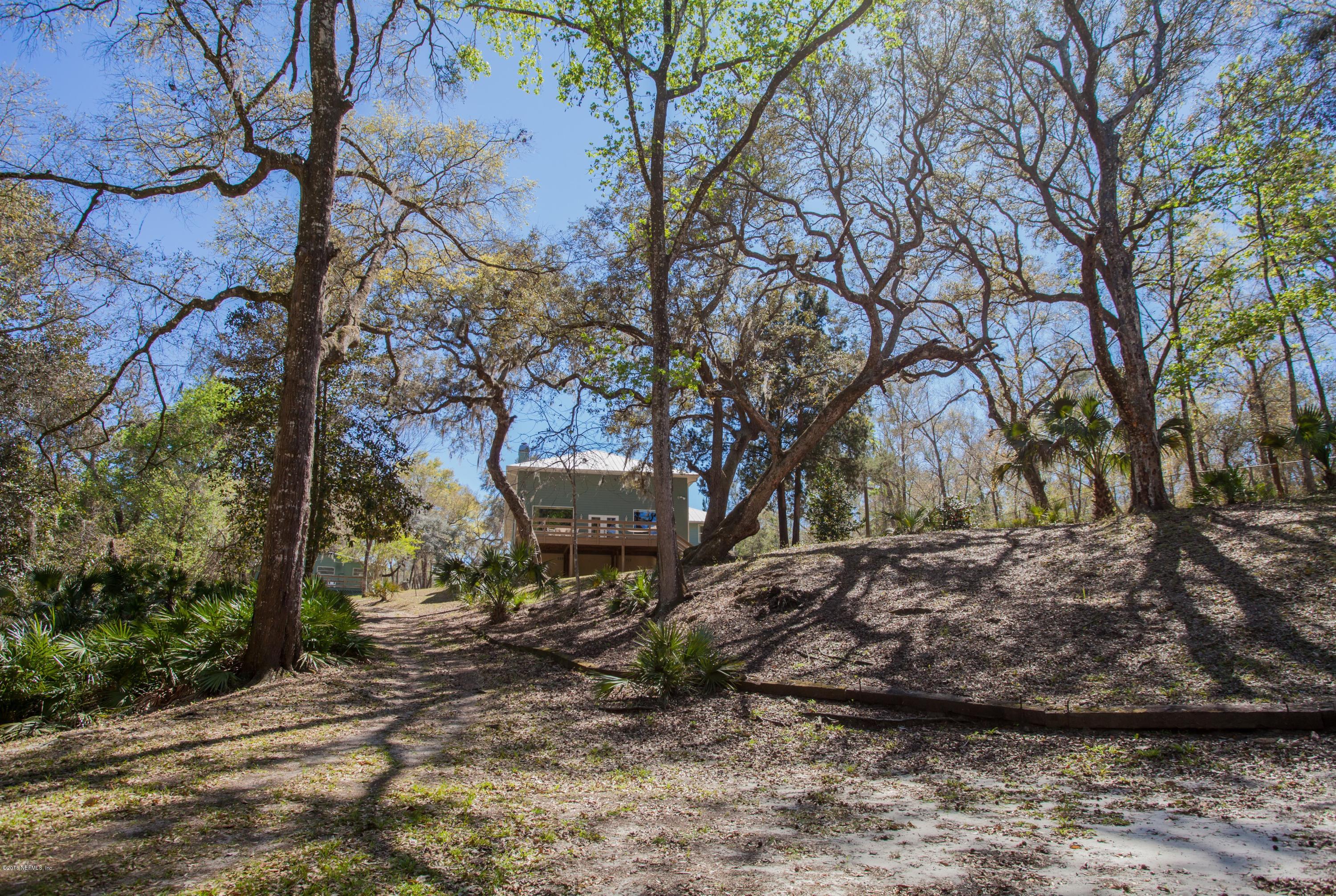 7986 National Forest Road Palatka, FL 32177 - Photo 27 of 31 a view of a backyard with table and chairs and a large tree