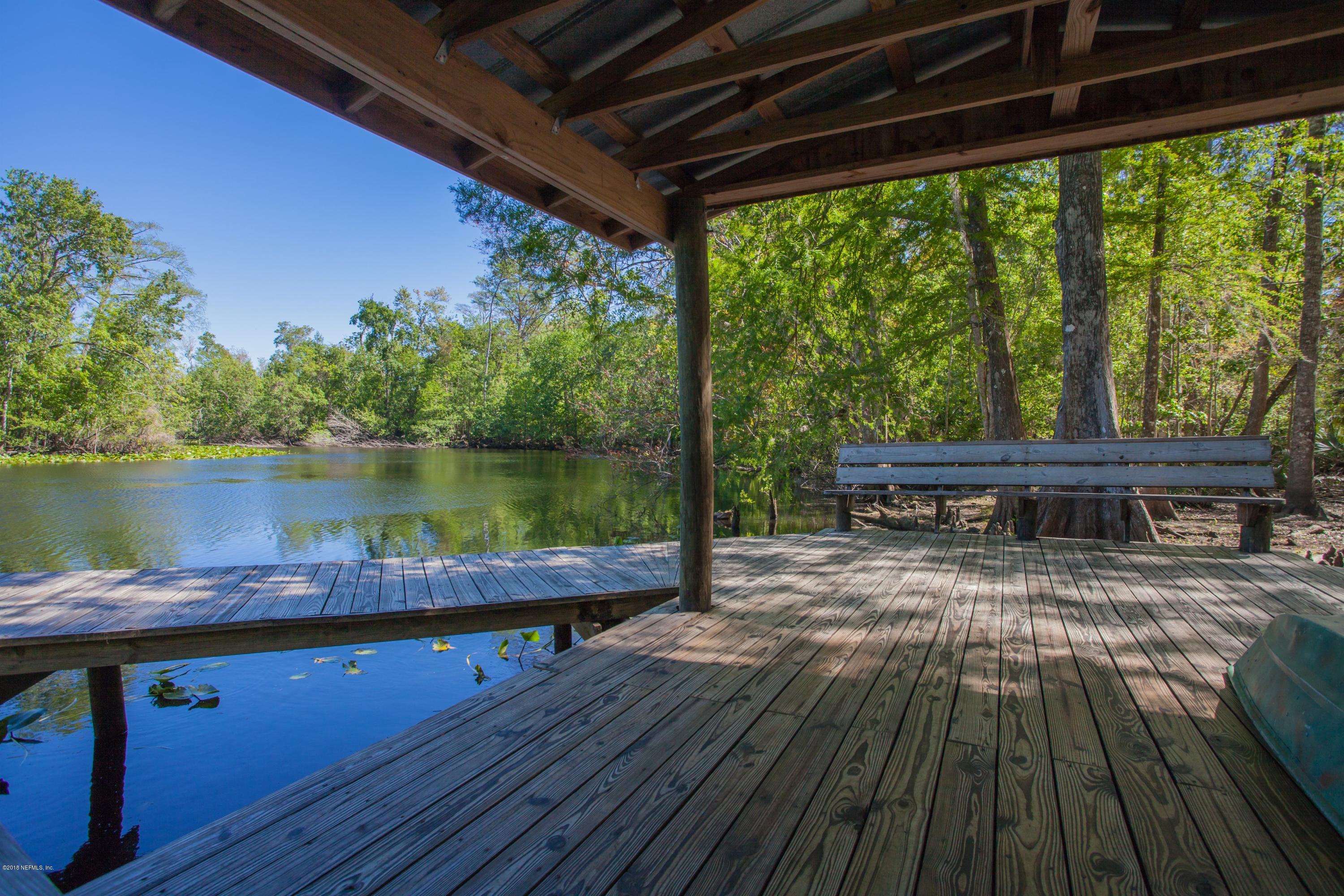7986 National Forest Road Palatka, FL 32177 - Photo 31 of 31 a view of a chairs and table on the wooden deck