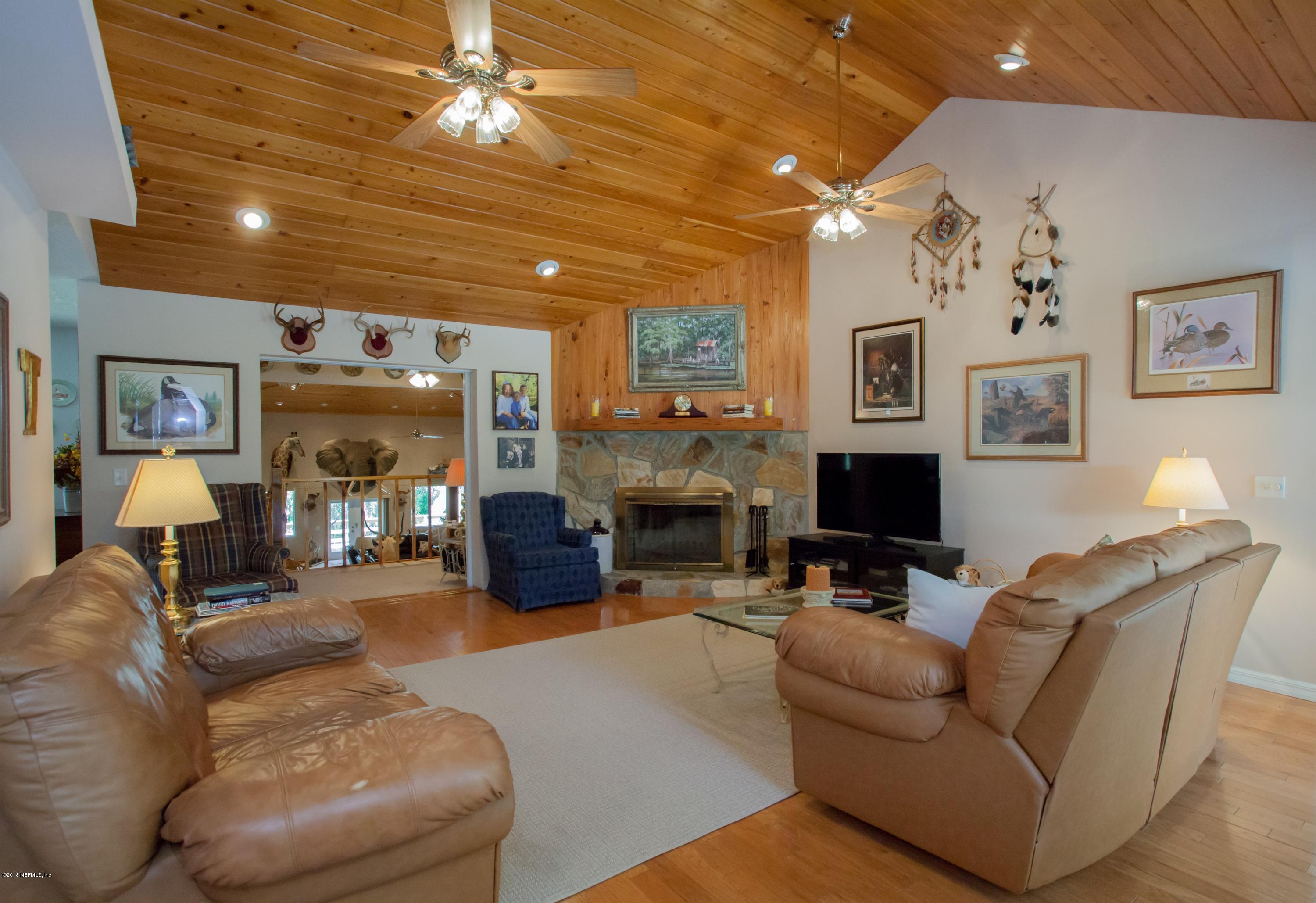 7986 National Forest Road Palatka, FL 32177 - Photo 6 of 31 a living room with fireplace furniture and a chandelier