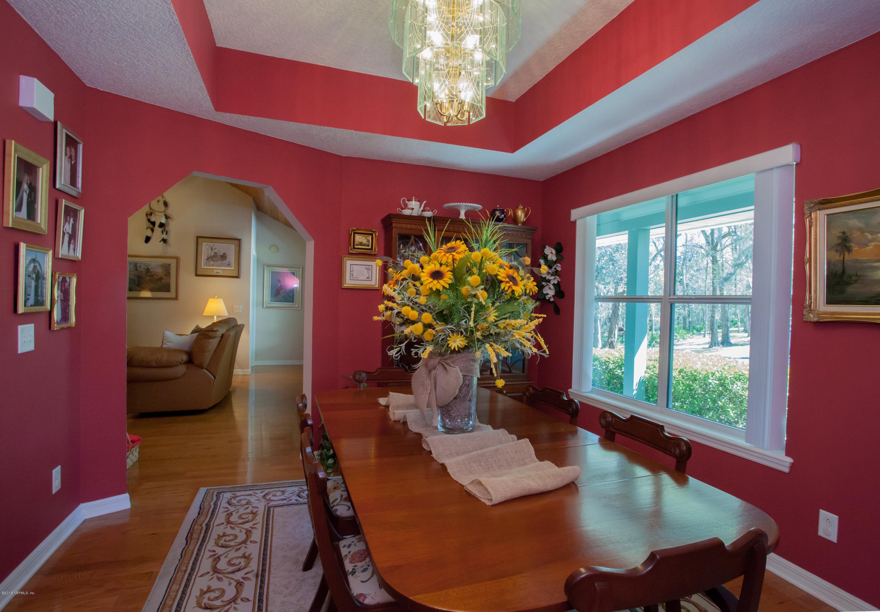 7986 National Forest Road Palatka, FL 32177 - Photo 8 of 31 a dining room with furniture a window and a chandelier