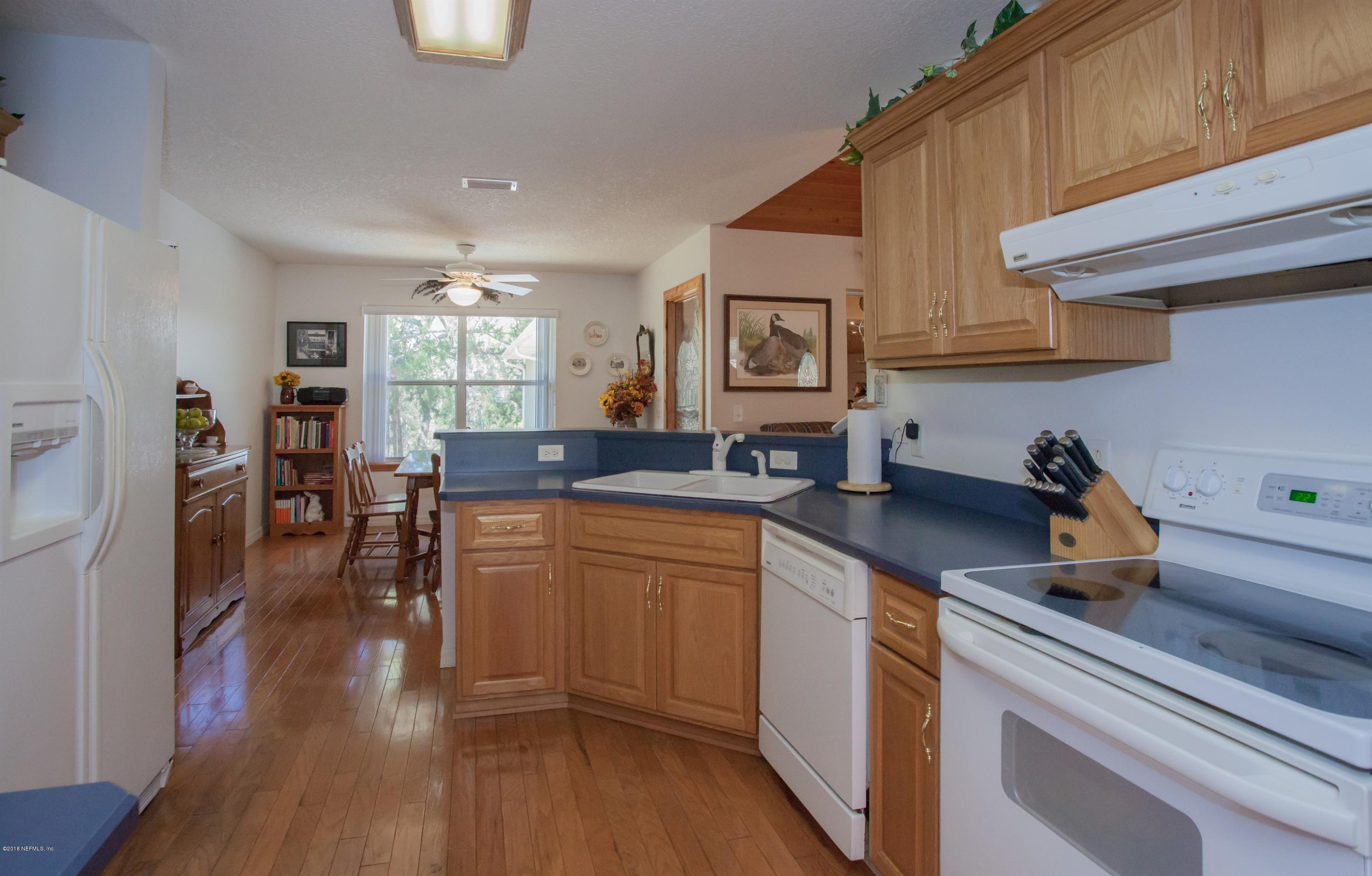 7986 National Forest Road Palatka, FL 32177 - Photo 10 of 31 a kitchen with stainless steel appliances granite countertop wooden floors and sink