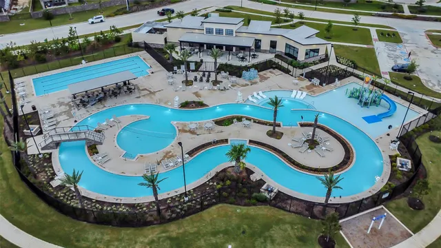 an aerial view of a pool patio yard and lake view
