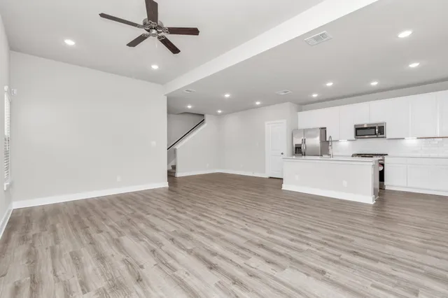 a view of kitchen with wooden floor and window