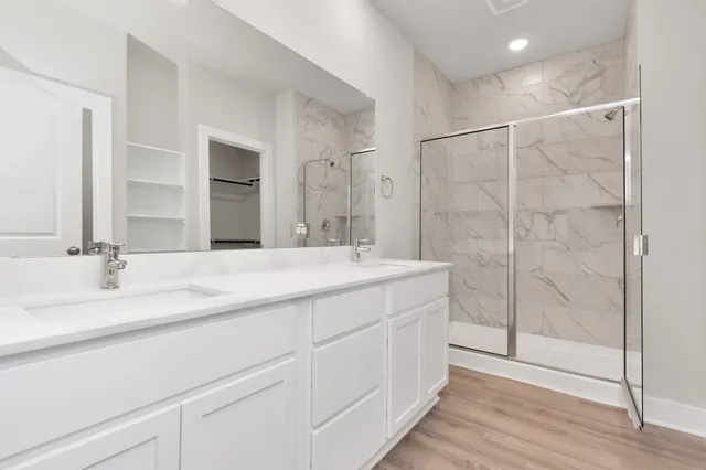 a bathroom with double vanity sink and a mirror