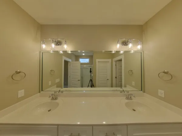 a bathroom with a tub a sink and a mirror