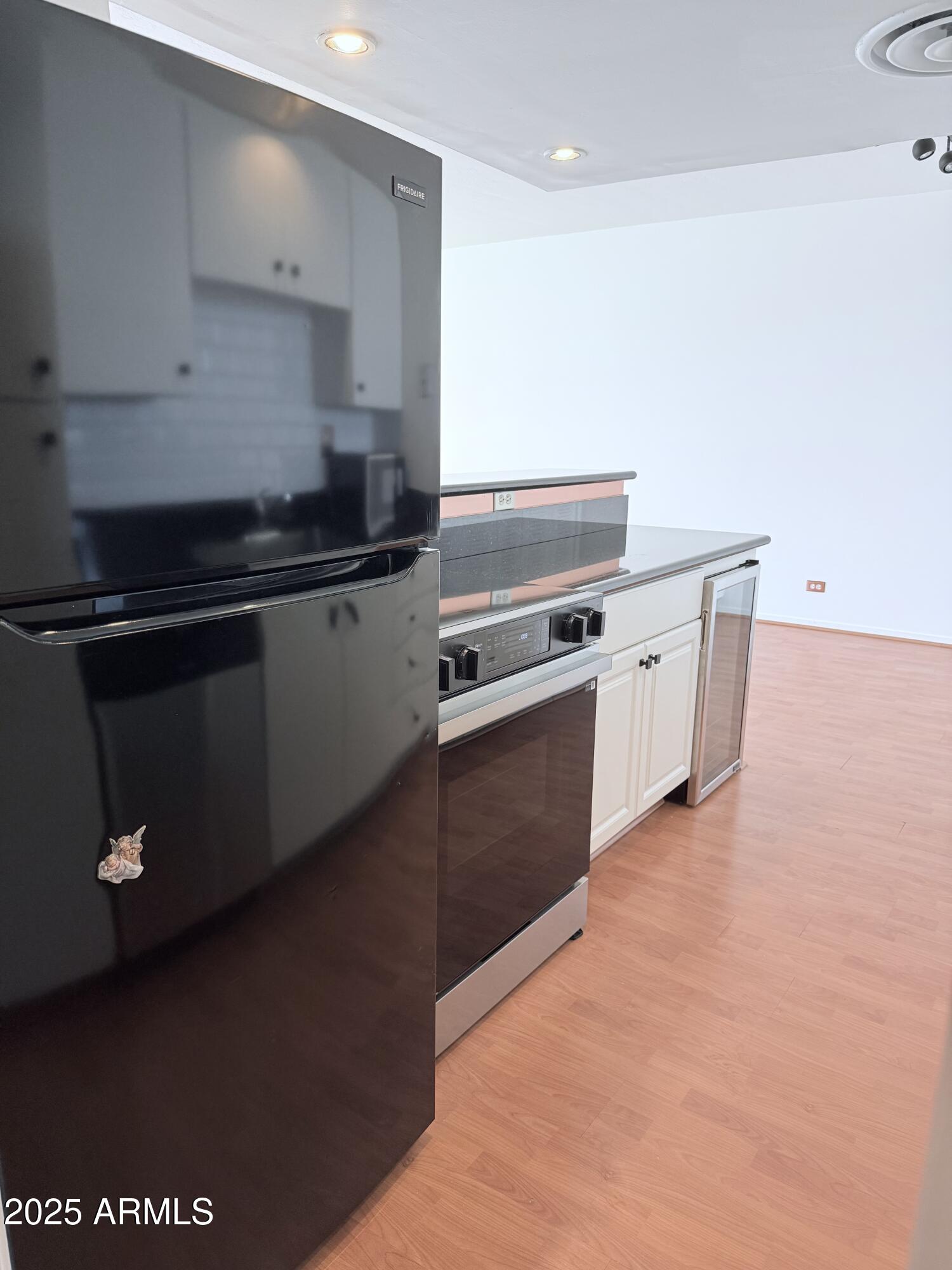 207 West Clarendon Avenue, Unit 4H Phoenix, AZ 85013 - Photo 12 of 37 a kitchen with stainless steel appliances a stove a sink and a refrigerator